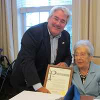 <p>Tuckahoe Mayor Steve Ecklond issuing a proclamation to Emily Viola.</p>