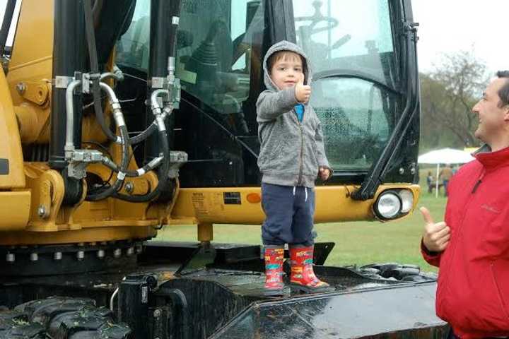 A young man enjoys the up-close experience on a piece of construction equipment at KIDZFEST, a fundraiser by the Human Services Council of Norwalk to support Children&#x27;s Connection.