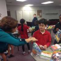 <p>A second grader and teacher assemble a meal.
</p>