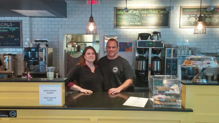 Owners Jessica and Josh Tolk stand behind the counter of their newly acquired restaurant on Weston Avenue.