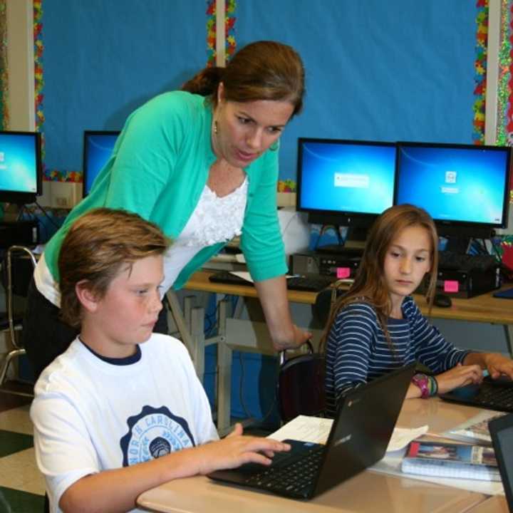 Bronxville fifth-grade teacher Stephanie Kennedy and her students Preston Maze and Caroline Ircha working with Chromebooks and Google Apps for Education made possible by Bronxville School Foundation grants.
