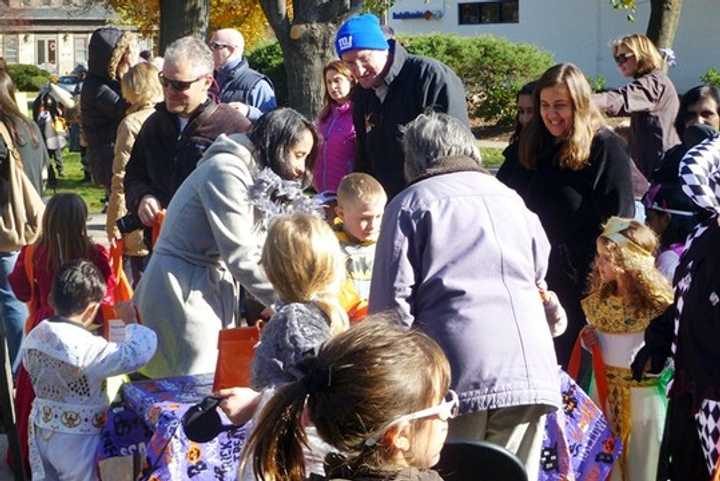 Kids go trick or treating on the green in Wilton in a past year. 