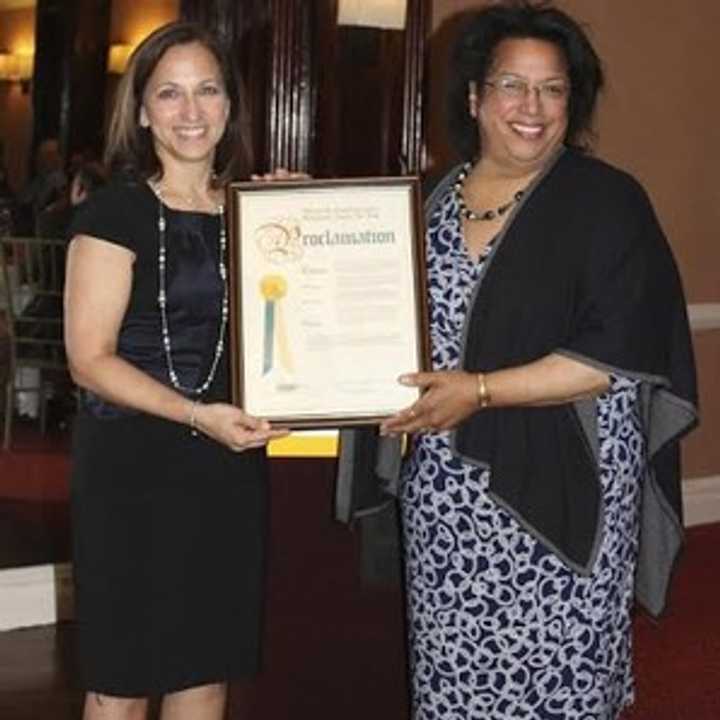 Shirley Acevedo Buontempo, founder and executive director of Latino U College Access, and Iris T. Pagan, executive director, Westchester County Youth Bureau, display a Westchester County proclamation at an event that honored county students.