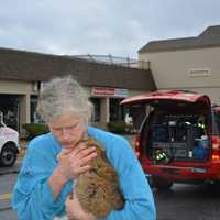 <p>A woman hugs Daisy the cat after she was retrieved. The woman declined to give her name but provided information about Daisy.</p>