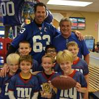 <p>Giants meet a Giant: Karl Nelson poses for photos with members of a Mahopac flag football team.</p>