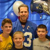 <p>Retired Giant Karl Nelson poses for a photo with Lucas Kowalski (left), Mason Nocito (center) and Nick Verrino (right). The three boys are 13 and live in Shrub Oak.</p>