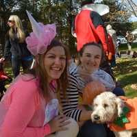 <p>Left to right: Kayla Smith, a YMCA Youth Program Director; Bonnie Fogarty, Executive Director of the local YMCA; and Cooper, a dog dressed as a pumpkin.</p>