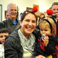 <p>A young child is dressed as a lady bug with her mother. </p>