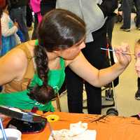 <p>Children get their faces painted at the parade. </p>