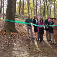 <p>Officials gather to cut the ribbon for the new trail. </p>