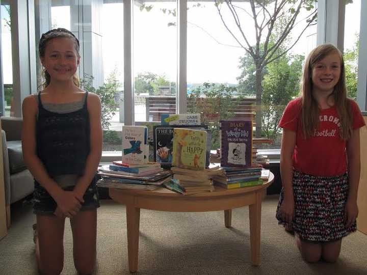 Whisconier Middle School students Emma Beal and Kailee Gunn organized a book drive for pediatric patients at Danbury Hospital. 