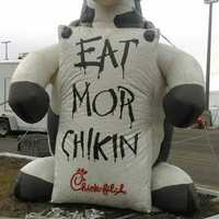 <p>A giant inflatable mascot cow bearing the sign &#x27;Eat Mor Chikin&#x27; is decorating the parking lot at the Danbury Fair Mall. </p>