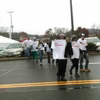 <p>The group of people who waited in live overnight in the parking lot - and in the rain - make their way into the Danbury Fair Mall on Thursday morning to claim their free meals for a year. </p>