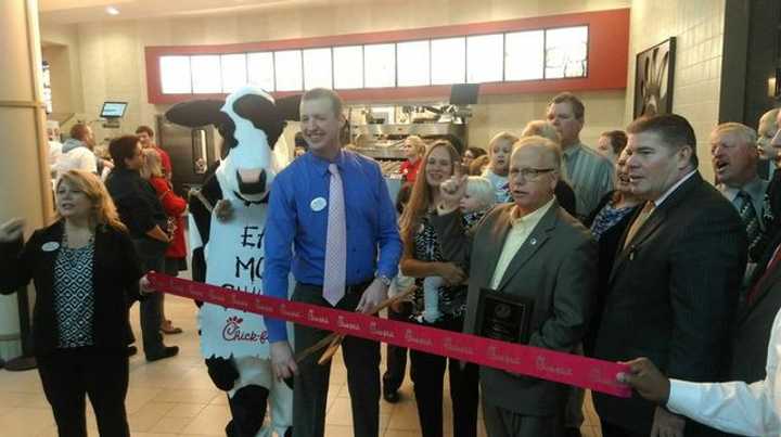 Rich Beattie, owner/operator of the new Chick-fil-A at the Danbury Fair Mall, holds a ribbon-cutting ceremony flanked by Mayor Mark Boughton and the fast-food restaurant&#x27;s mascot cow. 