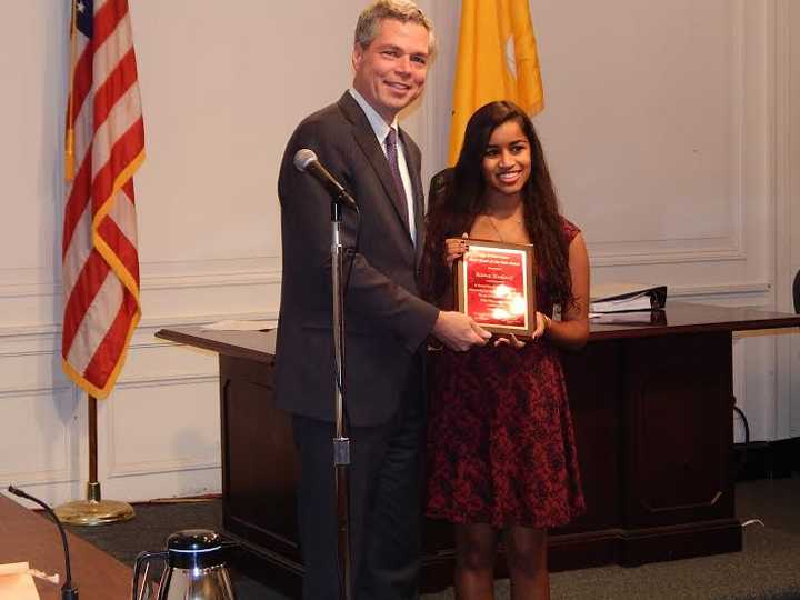 Mayor Thomas Roach presents Raina Kadavil with the White Plains Youth of the Year 2014 award.