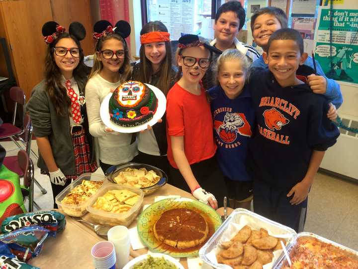 Briarcliff Middle School Spanish students pose with the Mexican food they made for El Dia de los Muertos (Day of the Dead.)