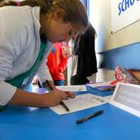 <p>A Briarcliff middle schooler signs a pledge to not use tobacco products for a year. </p>