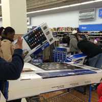 <p>Keifer Davis of White Plains checks out with her merchandise at Walmart in White Plains on Thanksgiving night.</p>