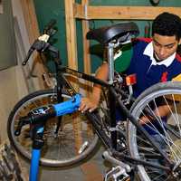 <p>A member of the club works on a bike. </p>