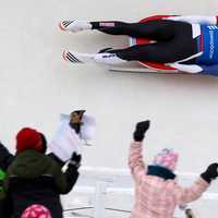 <p>Fans cheer as Tucker West slides past them at Lake Placid.</p>