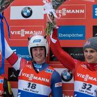 <p>Tucker West (center) of Ridgefield celebrates after his World Cup win last week in Lake Placid, N.Y.</p>