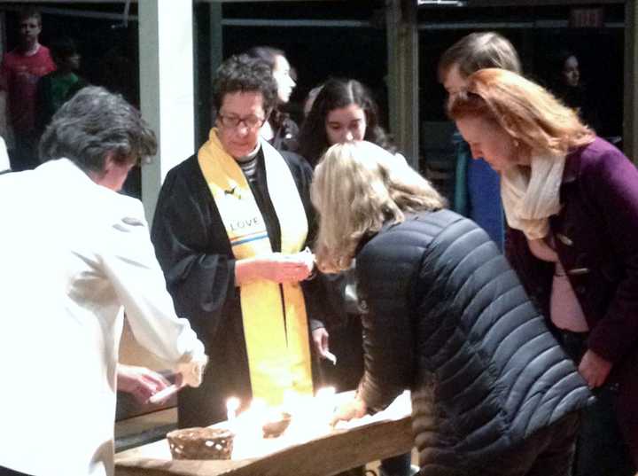 The Rev. Roberta Finkelstein leads a candle-lighting service in memory of those lost in the Sandy Hook School shooting on Dec. 14, 2012. The event was held at the Westport Unitarian Church.