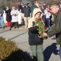 <p>Veteran John Driscoll and Boy Scout Michael Parkhurst lay one of seven ceremonial wreaths in honor of the different branches of the armed services at the Wreaths Across America ceremony in Darien.</p>