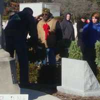 <p>Veteran Lenny Hunter, accompanied by boy scout John Parkhurst, salutes a ceremonial wreath laid in honor of the U.S. Coast Guard.</p>