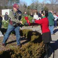 <p>Alice Ridgeway, Connecticut state vice regent of the Daughters of the American Revolution, and Katherine Love, regent of the Good Wife&#x27;s River chapter of the DAR, hand David Polett a remembrance wreath in honor of POW and MIA soldiers.</p>