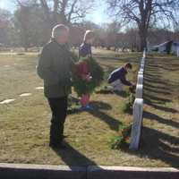 <p>Darien volunteers lay wreaths and pause to reflect during the Wreaths Across America ceremony.</p>