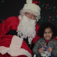 <p>Santa Claus and a young girl at the Ossining Community Center. </p>