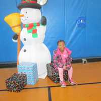 <p>Africo Lewis with Frosty the Snowman.</p>