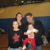 <p>Manuel Quezada with his family in line to meet Santa at the Ossining Community Center.</p>