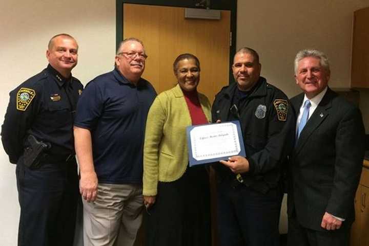 Norwalk Police Chief Thomas Kulhawik, Commissioner Charlie Yost, Commissioner Fran Collier-Clemmons, Officer Hector Delgado and Mayor Harry Rilling at the Police Commission meeting where Delgado was named Officer of the Month.