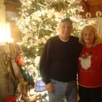 <p>Rick and Joan Setti in their living room, which is just as adorned with Christmas decorations as their front lawn.</p>