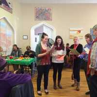 <p>A group of volunteers sings. </p>