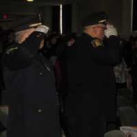 <p>Police Academy graduates salute during the national anthem sung by officers from Hastings-On-Hudson and Yonkers.</p>