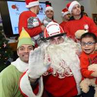 <p>Buddy the Elf, left, with Santa Claus at John A. Coleman School.</p>