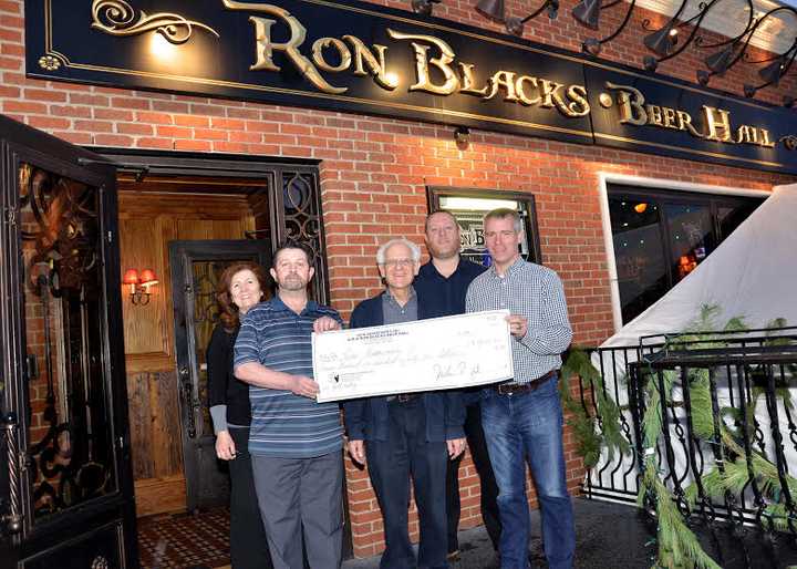 Gary Gibson, center, director of the, Laboratory for Mitochondrial Biology and Metabolic Dysfunction in Neurodegeneration at Burke Medical Research Institute, Ron Blacks owner Declan Rainsford, far right,  and members of the Ron Blacks staff.