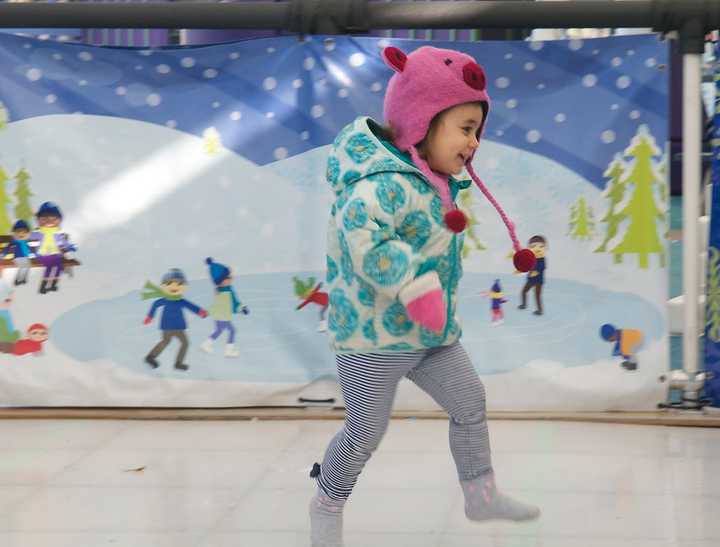 Lily Schlafman, 2, of New Canaan, checks out the sock skating rink at Stepping Stones Museum.