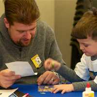 <p>Cortlandt Manor resident Eric Rauschenbach and son, Aaron, 5, work on their drawing for MLK day.</p>