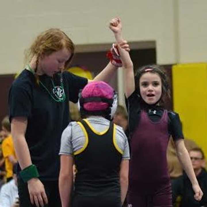 Calli Gilchrist, a third-grader, has his arm raised in victory after beating an opponent. 