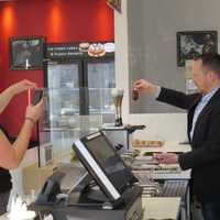 <p>Lead designer Tom Kowalski shows the proper technique to dipping an ice cream bar in Bronxville.</p>