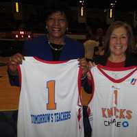 <p>Bettye H. Perkins, left, founder and chief executive officer of Today&#x27;s Students, Tomorrow&#x27;s Teachers and Deborah Fay of Entergy display jerseys given away at Friday&#x27;s basketball game.</p>