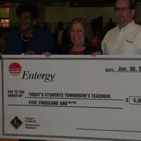 <p>Deborah Fay, second from left, and Dave Cooke, second from right, both from Entergy, display a check symbolizing the $5,000 donation to Today&#x27;s Students, Tomorrow&#x27;s Teachers of White Plains, represented by its founder, Bettye H. Perkins, left.</p>