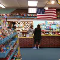 <p>Marilyn Crofutt helps a customer on a slow Friday afternoon.</p>