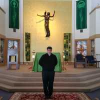 <p>The Rev. Bret Stockdale, S.J., stands in front of the alter at Egan Chapel on Fairfield University&#x27;s Campus.</p>