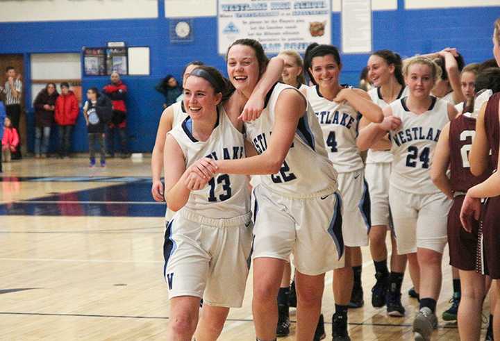 Westlake&#x27;s Faith Lovett (13) and Katie Schmid (22) hug after defeating Valhalla, 59-38.