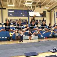 <p>WHS cheer team jumps.</p>