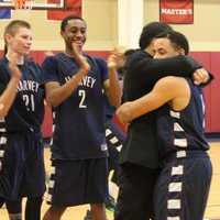 <p>Ricky Hicks&#x27; teammates and coaches, Mike Rubenfeld (left) and Dom Narcisco (right), pose for celebratory photo after the senior point guard collects his 1000th career point for Harvey</p>